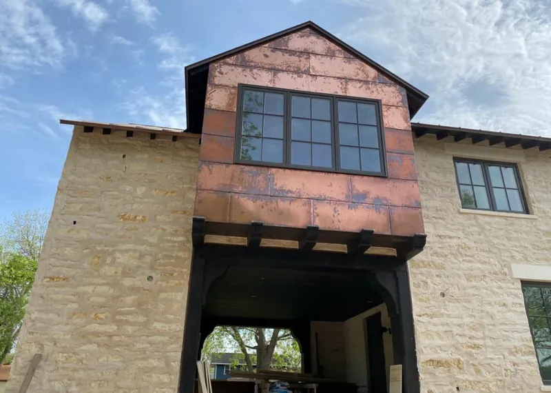 Copper metal panel facade on a stone building for Skylight Installation in Charleston