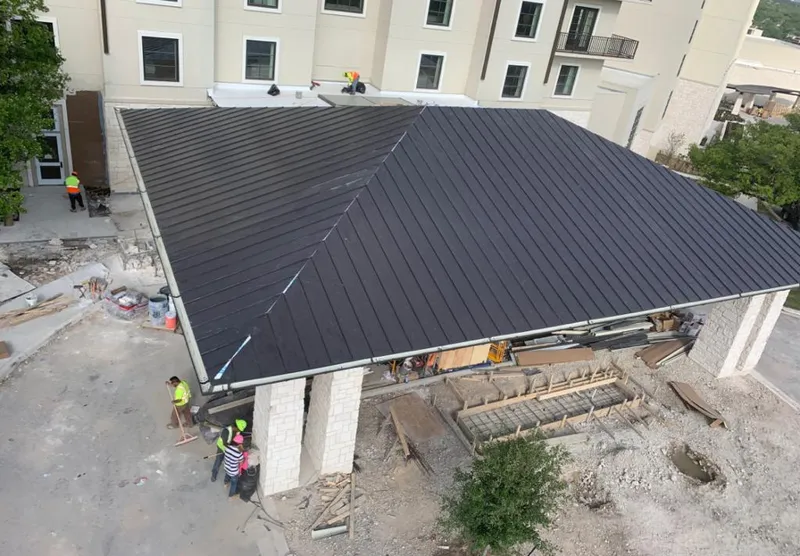 Metal roofing installation team working on a commercial building in Charleston